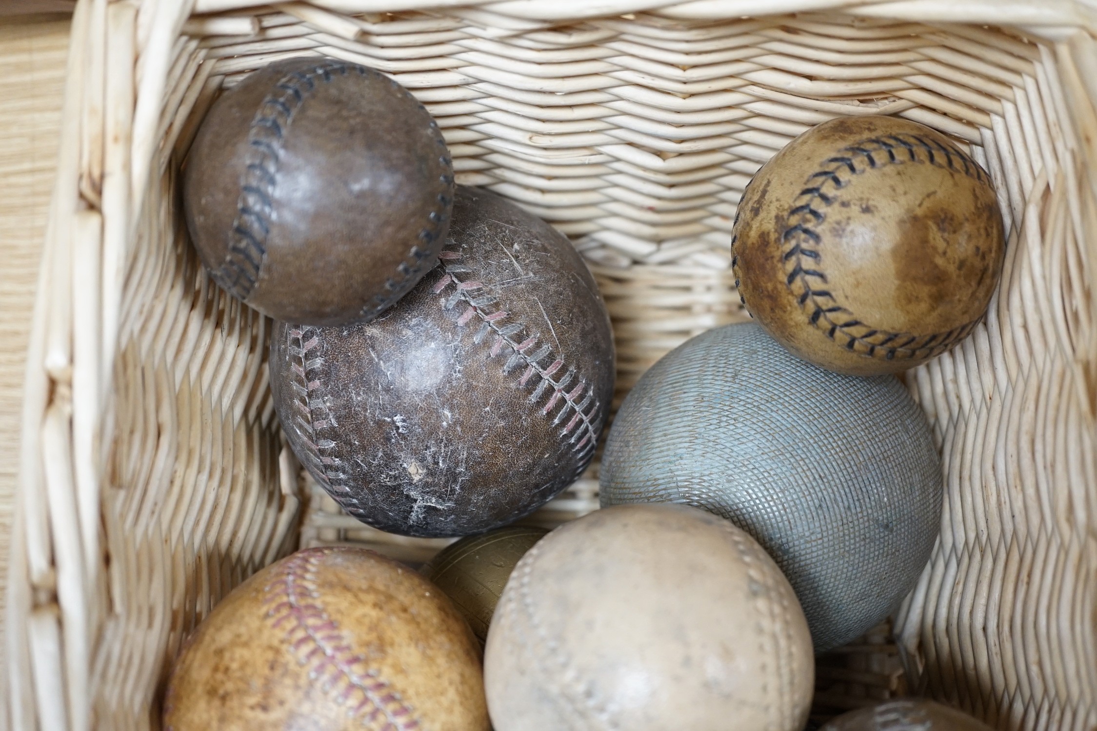 A collection of leather cricket and sporting balls